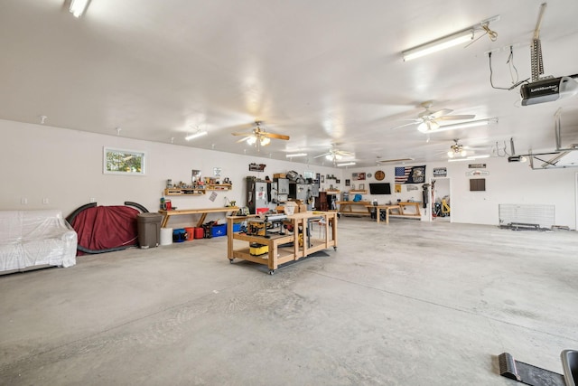 garage with a garage door opener and a workshop area