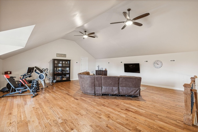 living room featuring lofted ceiling, light hardwood / wood-style floors, and ceiling fan