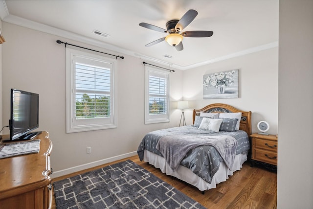 bedroom with ceiling fan, ornamental molding, and dark hardwood / wood-style floors