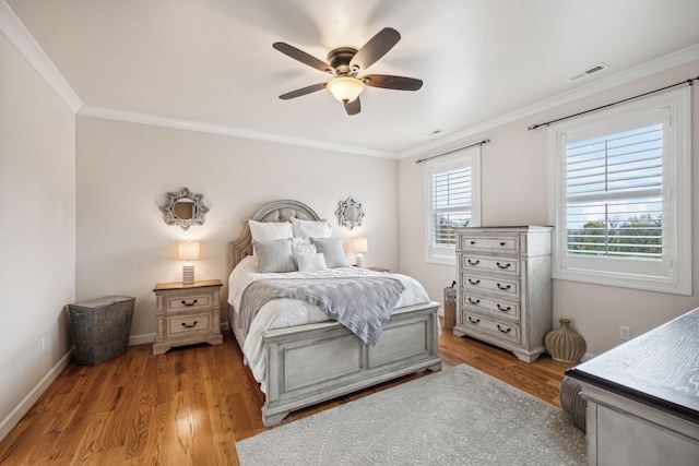 bedroom featuring crown molding, wood-type flooring, and ceiling fan