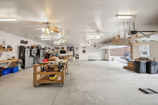 garage featuring a garage door opener and stainless steel refrigerator