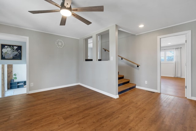 unfurnished room featuring hardwood / wood-style flooring, ornamental molding, and ceiling fan