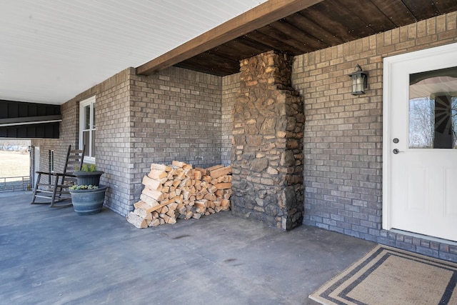 view of exterior entry with a patio area