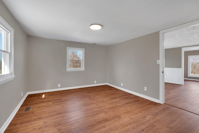 spare room featuring wood-type flooring