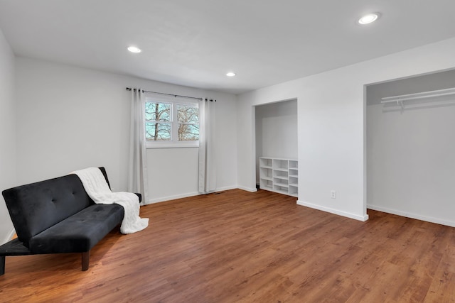 sitting room with hardwood / wood-style flooring