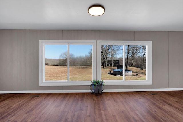 empty room with hardwood / wood-style flooring