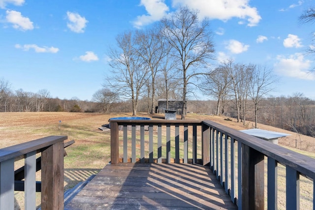 wooden terrace with a storage shed and a yard