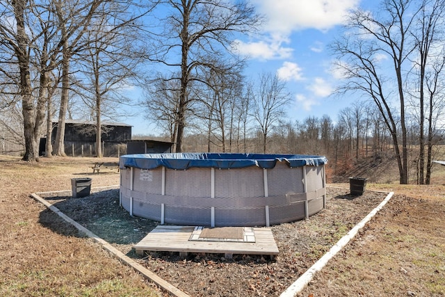 view of yard with a covered pool