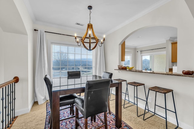 dining room featuring a notable chandelier and ornamental molding