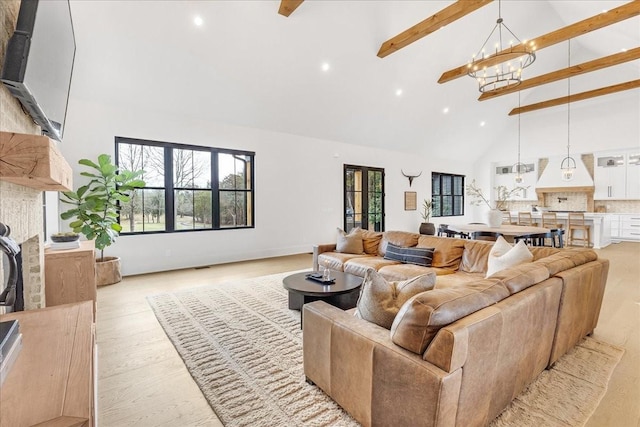 living room featuring beam ceiling, light hardwood / wood-style flooring, high vaulted ceiling, and a chandelier