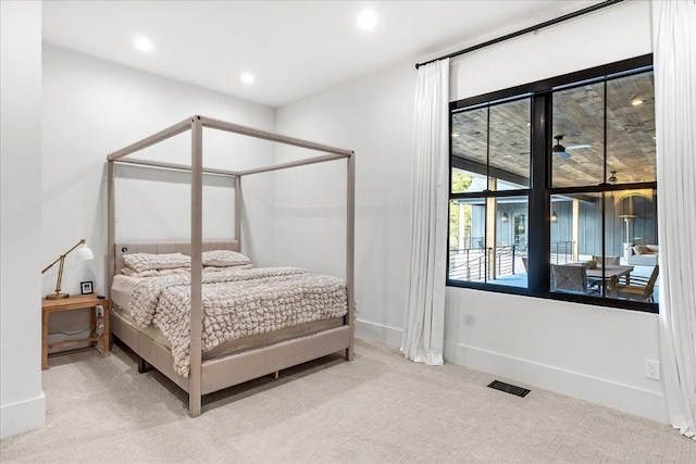 bedroom featuring light carpet