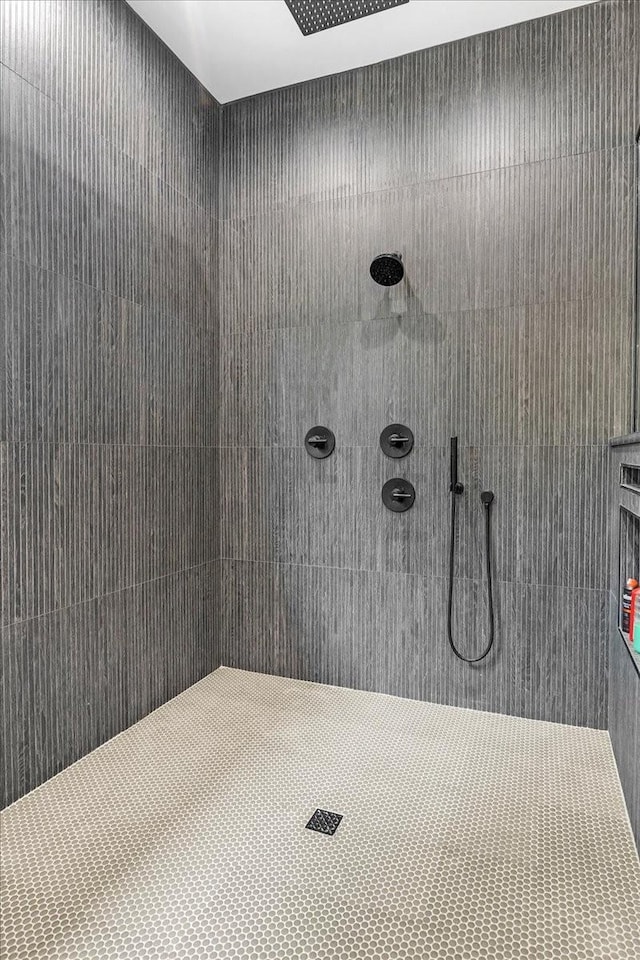 bathroom with a tile shower