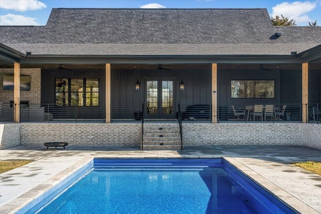 view of pool featuring french doors, ceiling fan, and a patio area