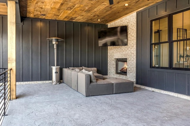 view of patio with ceiling fan and a fireplace