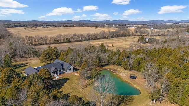 aerial view featuring a water and mountain view and a rural view