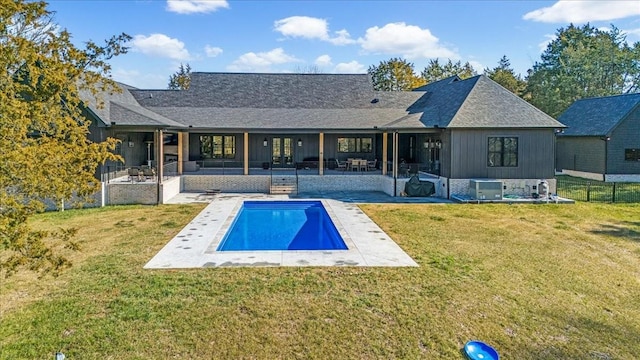 rear view of house with a yard, a patio area, and central AC