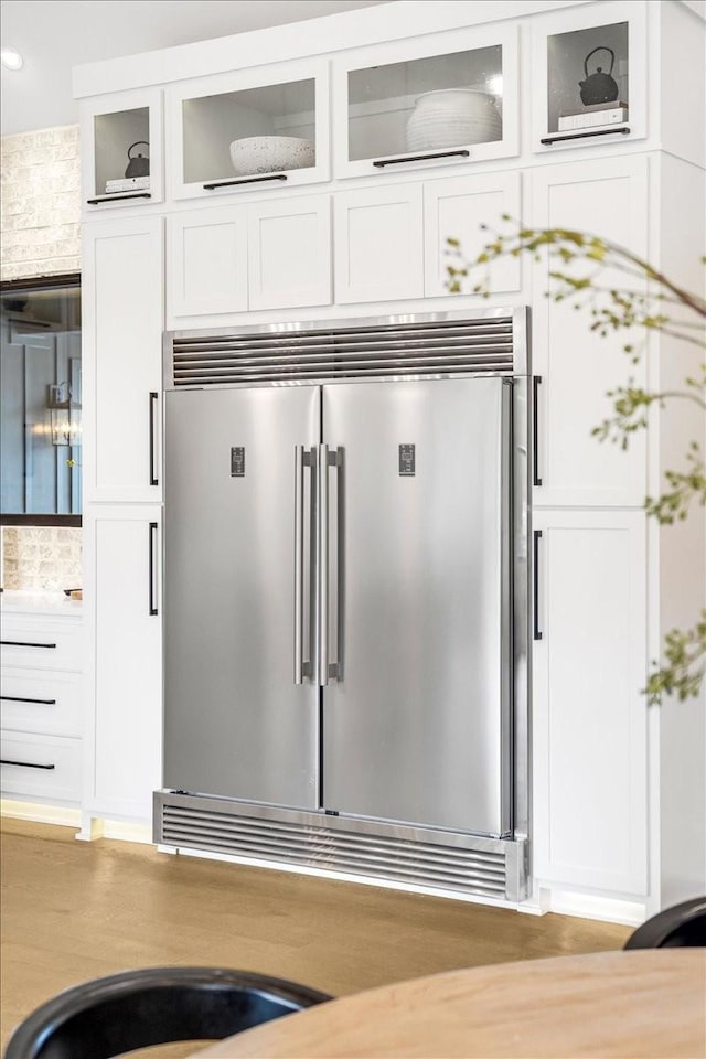 details featuring white cabinetry and stainless steel built in refrigerator