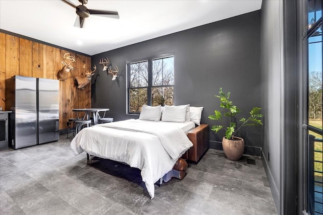 bedroom with ceiling fan, stainless steel fridge, and wooden walls