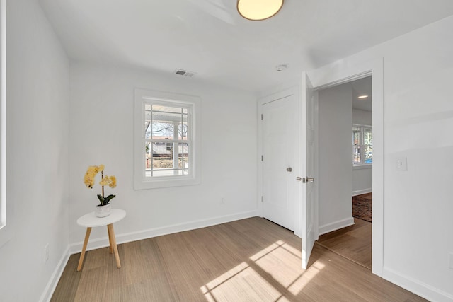 empty room featuring hardwood / wood-style floors and a healthy amount of sunlight