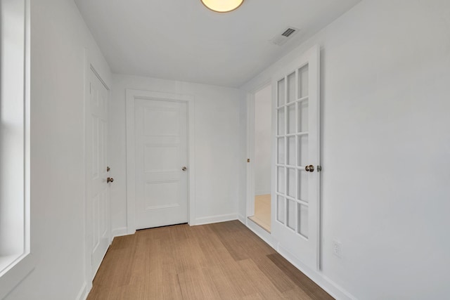 corridor with light wood-type flooring