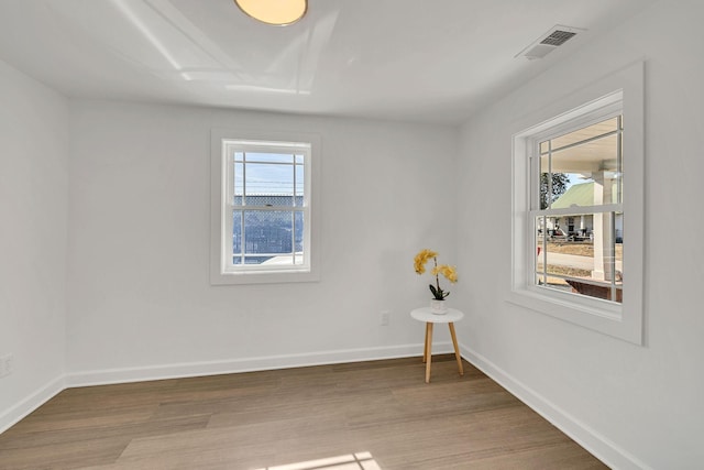 unfurnished room with wood-type flooring