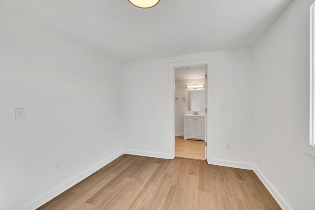 unfurnished room featuring sink and light wood-type flooring