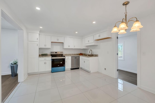 kitchen featuring decorative light fixtures, stainless steel appliances, and white cabinets