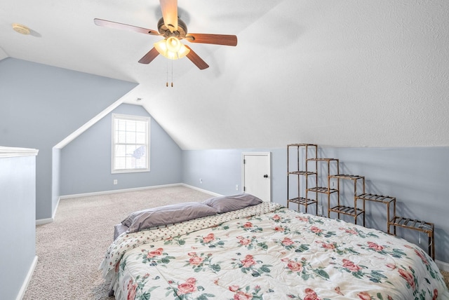 carpeted bedroom with ceiling fan and vaulted ceiling