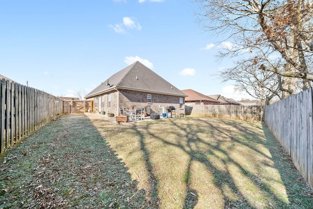 rear view of house with a patio area and a lawn