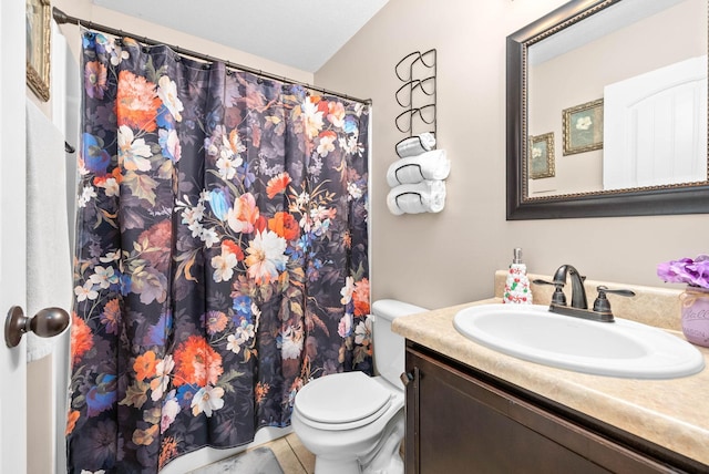 bathroom featuring vanity, tile patterned flooring, and toilet