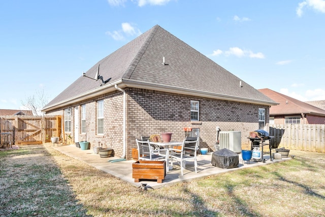 rear view of house with a yard and a patio