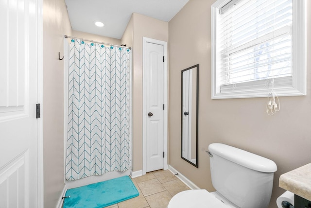 bathroom with a shower with curtain, tile patterned floors, and toilet