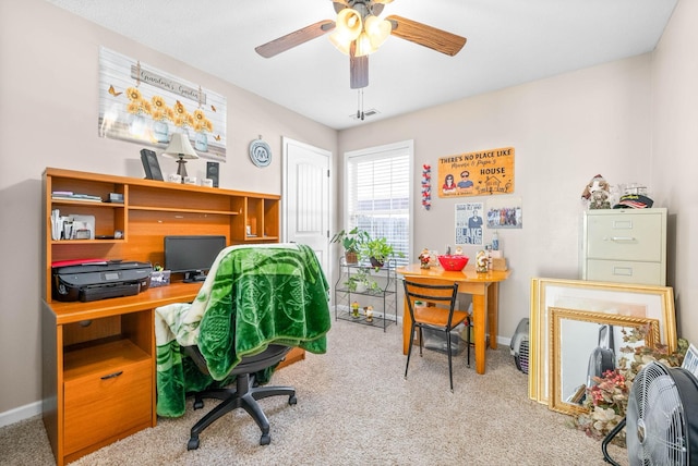 carpeted office space featuring ceiling fan