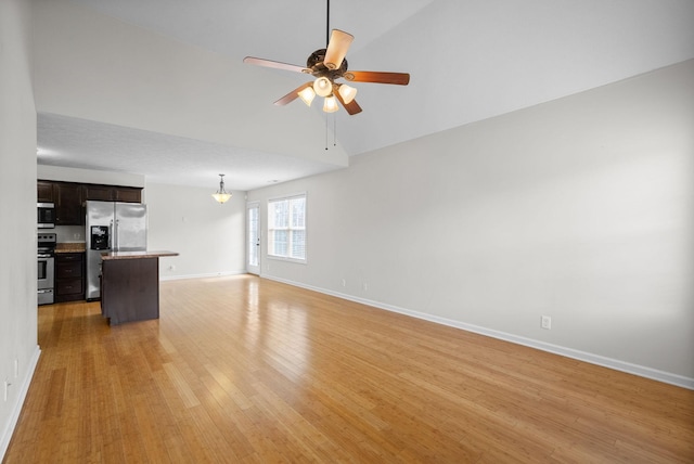 unfurnished living room with light wood finished floors, a ceiling fan, and baseboards