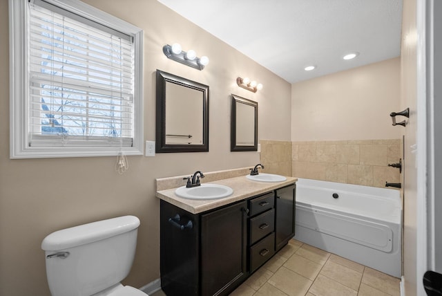 full bathroom with a garden tub, tile patterned flooring, a sink, and toilet