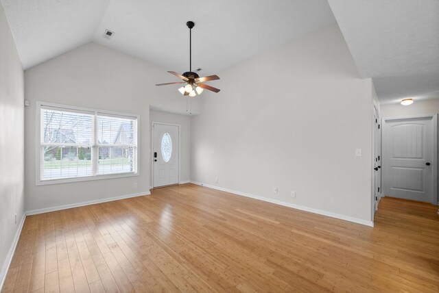 unfurnished living room with lofted ceiling, visible vents, a ceiling fan, light wood-type flooring, and baseboards