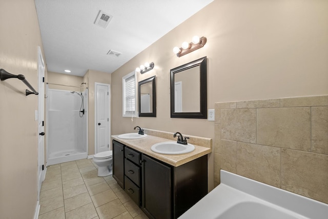 bathroom with a shower, a sink, and visible vents