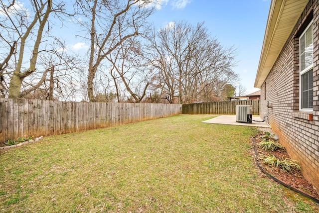 view of yard featuring a fenced backyard, a patio, and central AC unit