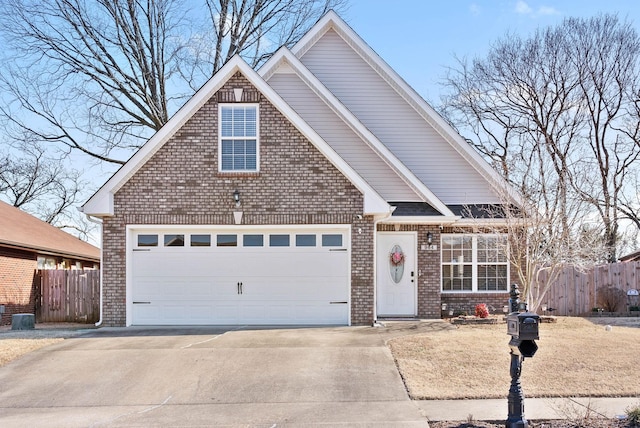 view of front of house featuring a garage, concrete driveway, brick siding, and fence