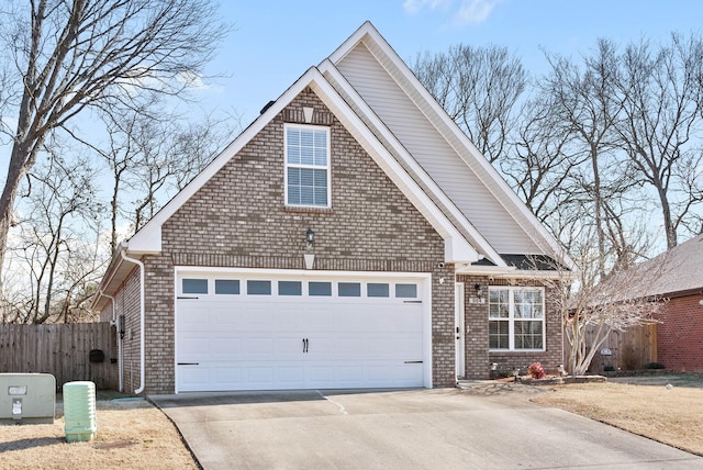 traditional-style home featuring a garage, fence, concrete driveway, and brick siding