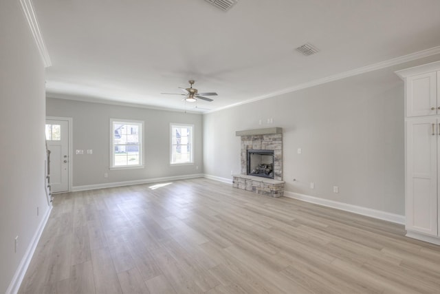 unfurnished living room with crown molding, a fireplace, light hardwood / wood-style floors, and ceiling fan