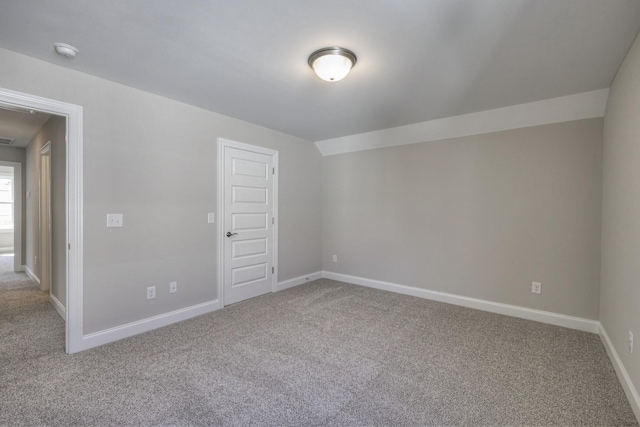 additional living space with carpet flooring and vaulted ceiling