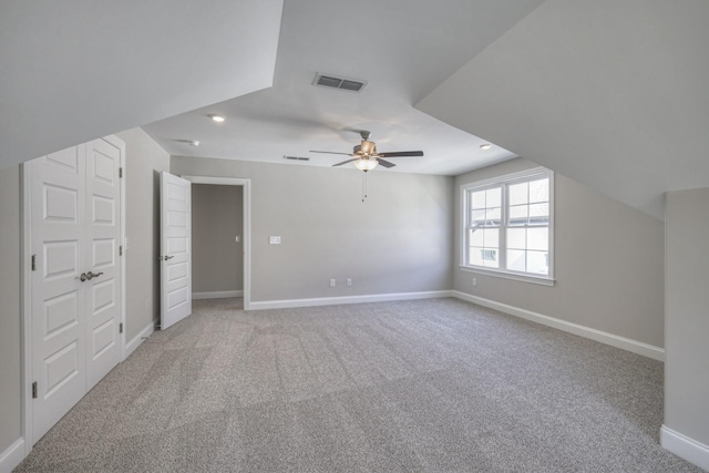 bonus room with lofted ceiling, light carpet, and ceiling fan