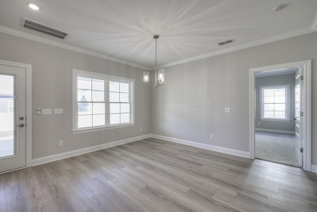 unfurnished dining area featuring crown molding, an inviting chandelier, and light hardwood / wood-style floors