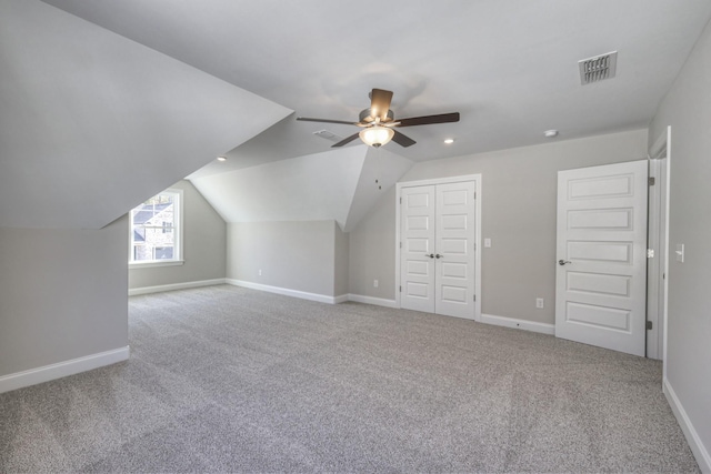 bonus room with vaulted ceiling, carpet floors, and ceiling fan