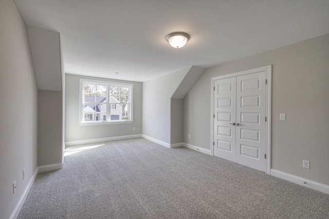 bonus room featuring light carpet