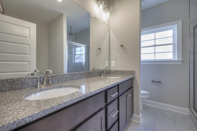 bathroom featuring vanity, a shower with door, and toilet