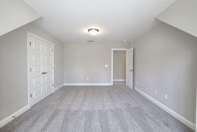 additional living space featuring carpet