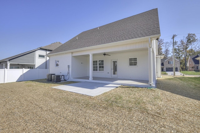 rear view of house with a yard, central air condition unit, ceiling fan, and a patio area