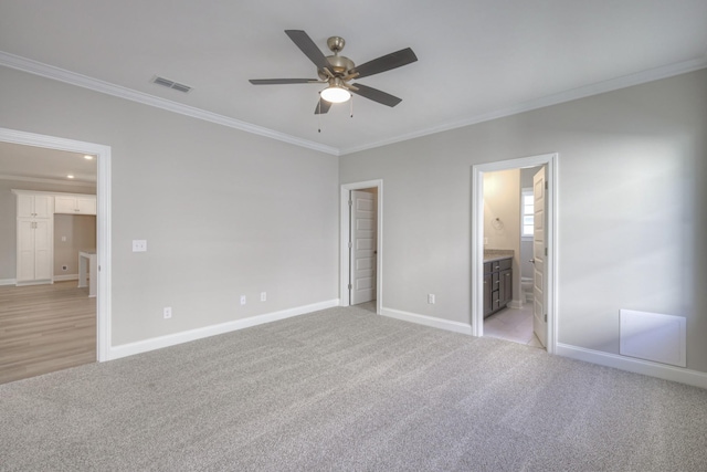 unfurnished bedroom featuring crown molding, ceiling fan, connected bathroom, and light carpet